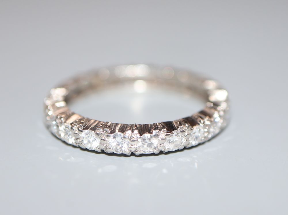 A white metal and diamond set full eternity ring, size M, gross 3.3 grams.